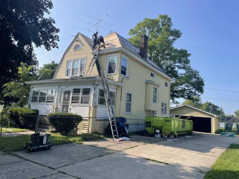 Gutter and downspout installation on residential home